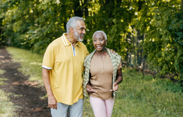 Senior male and female walking on outdoor path